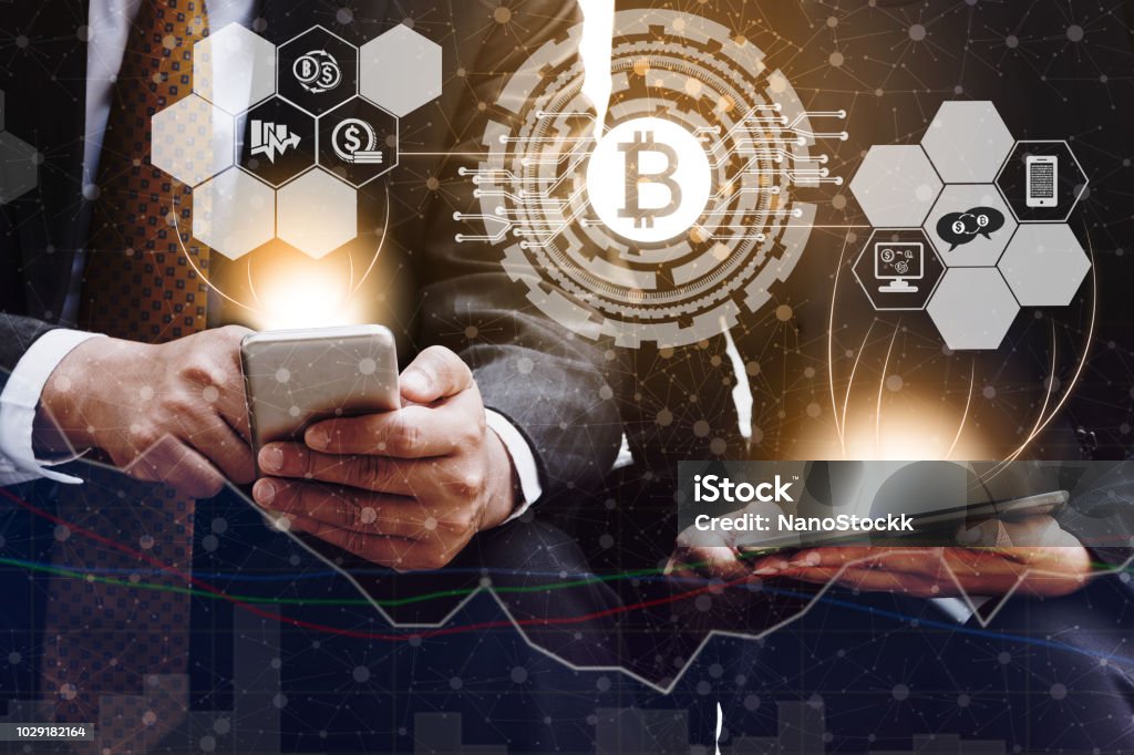 Bitcoin BTC and Cryptocurrency Trading Concept Bitcoin and cryptocurrency investing concept - Businessman using mobile phone application to trade Bitcoin BTC with another trader in modern graphic interface. Blockchain and financial technology. Cryptocurrency Stock Photo