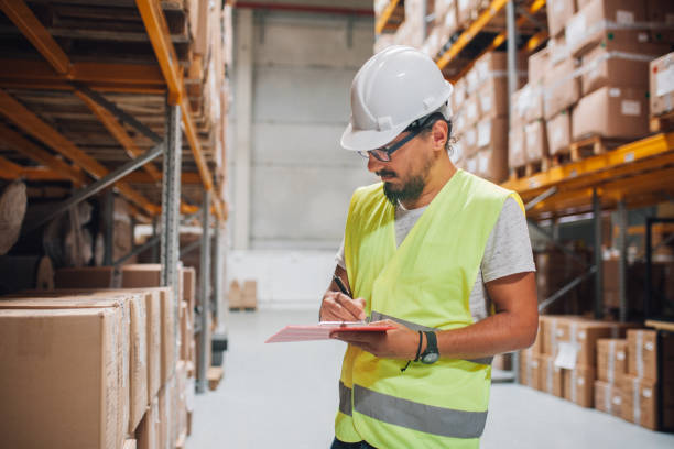 istock Male Warehouse Employee Doing Inventory Check In Warehouse 1029191564
