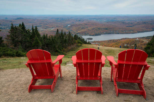 istock Three red chairs at the top of Mont Tremblant with panoramic views, Quebec, Canada 1029191984