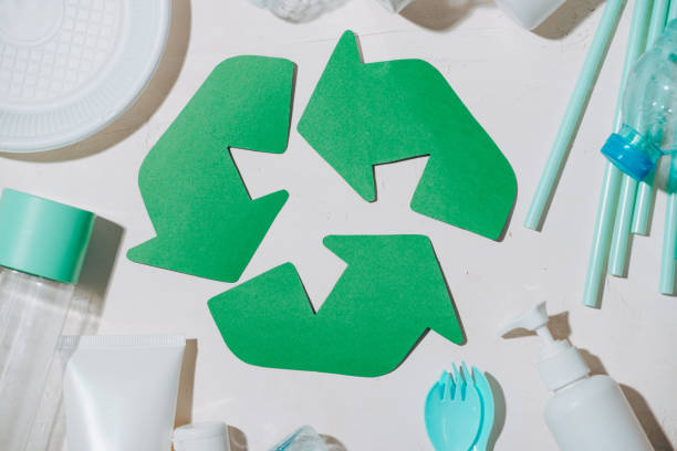 istock waste recycling eco symbol with garbage disposal on stone table background top view 1029194232