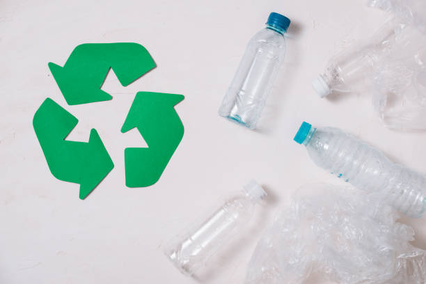 istock waste recycling eco symbol with garbage disposal on stone table background top view 1029194374