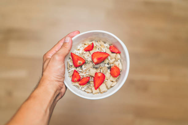 istock Man holding gluten free musli with strawberries 1029194564