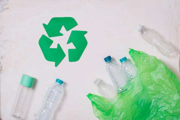 istock waste recycling eco symbol with garbage disposal on stone table background top view 1029194576