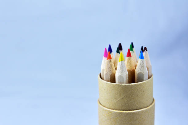 istock Color pencil in wooden box on light blue background 1029198090