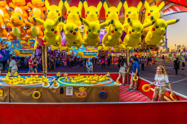 Ring a Duck Game Phoenix, Arizona - October 25, 2017: A Ring a Duck game operator waits for players at the Arizona State Fair in Phoenix. midway fair stock pictures, royalty-free photos & images