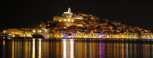 istock Ibiza town, (Eivissa) - at night lights reflected across the harbour. 1029206794