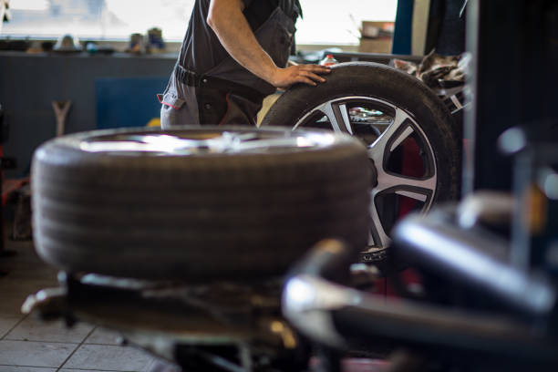 Wheel balancing or repair and change car tire at auto service garage stock photo