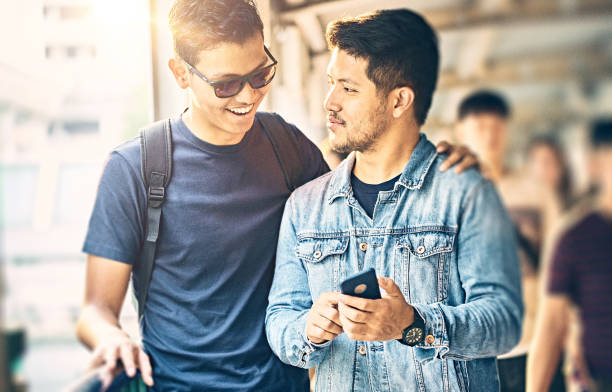 istock Two asian men using smart phone in Bangkok 1029224018