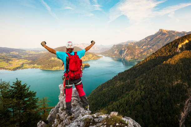 istock Climber with high-raised arms on mountain peaks in the Alps 1029228676
