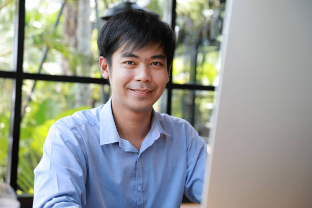 istock asian businessman smiling and looking to camera 1029231606