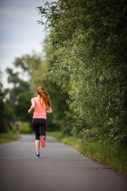 istock Young woman running outdoors on a lovely sunny winter/fall day 1029231896