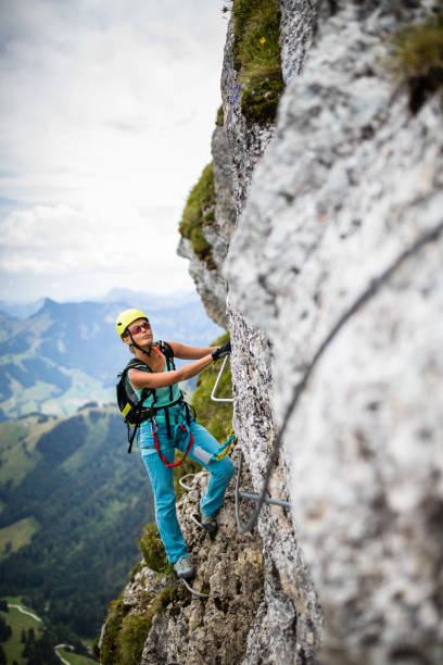 istock Pretty, female climber on a via ferrata 1029239880