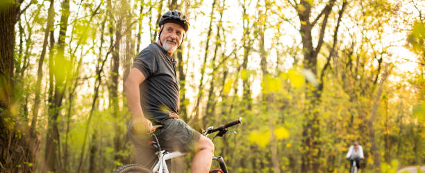 senior man on his mountain bike outdoors - cycling cyclist bicycle men imagens e fotografias de stock