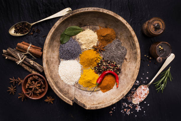 assortment of spices, tradition and culture vintage wooden plate full of colorful spices and ingredients seasoning stock pictures, royalty-free photos & images