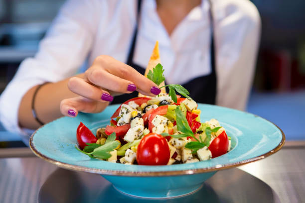 istock Happy chef decorating a plate at a restaurant 1029249462