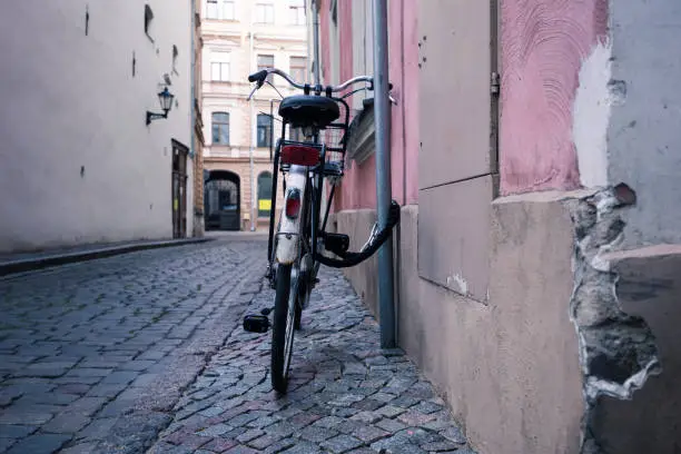 A bike in the old streets as a symbol of eco-friendly transport. Cobblestone pavement in the historic center of Riga, Latvia.