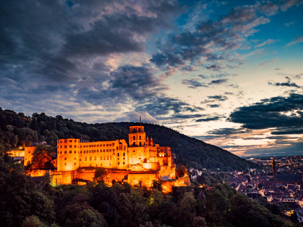 Heidelberg castle and town at night Heidelberg Germany , August 11th of 2018 Panorama of the castle and the beautiful town of Heidelberg at dusk. Located in Baden-WÃ¼rttemberg it was founded arount the V century although before romans and germanic tribes were living in the area. Today it is known because it is a famous university town. heidelberg germany photos stock pictures, royalty-free photos & images