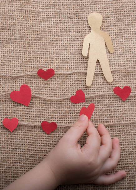 istock Paper man shape in hand in the view 1029255532