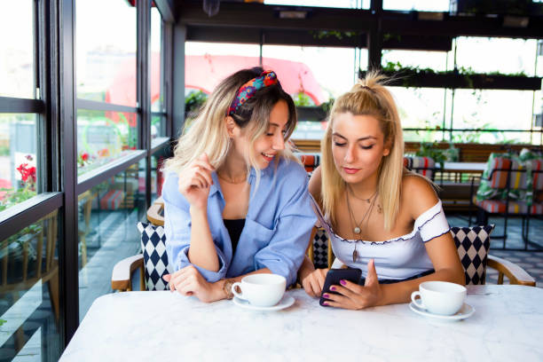 istock Friends with tablet and hot drinks 1029258942