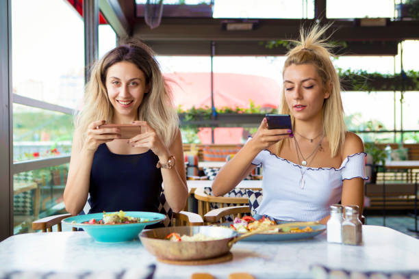 istock Woman's hands photograph her meal with her mobile phone 1029258992