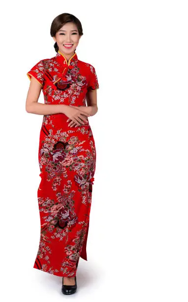 Asian lady in Chinese new year dress or cheongsam in standing and walking position on isolated white backgroung, this immage included for clipping part for easy to use
