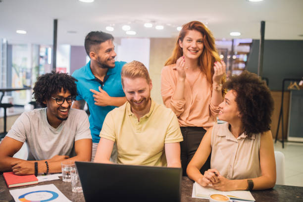 istock Happy young people working together in an office 1029264872