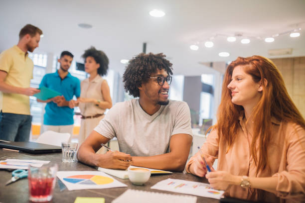istock Joyful young coworkers looking at each other 1029268790