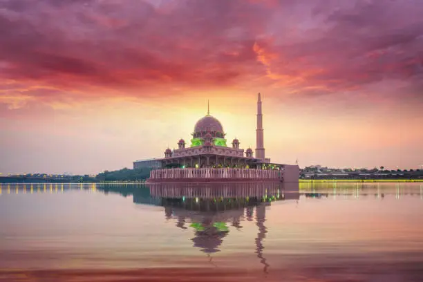 Photo of Mosque in Kuala lumpur city on morning sunrise time with refrection in water