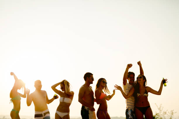 istock Group of happy young people enjoying summer sunset 1029272788