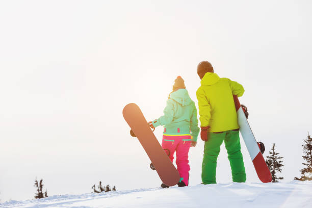 istock Two snowboarders stands with snowboards 1029280660