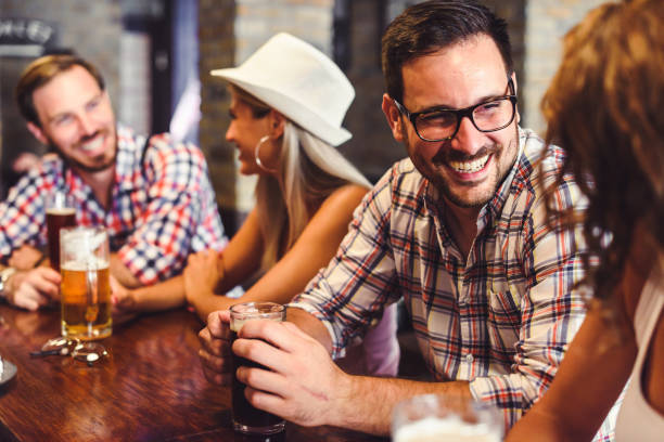 istock Young people drinking beer and laughing together 1029287536