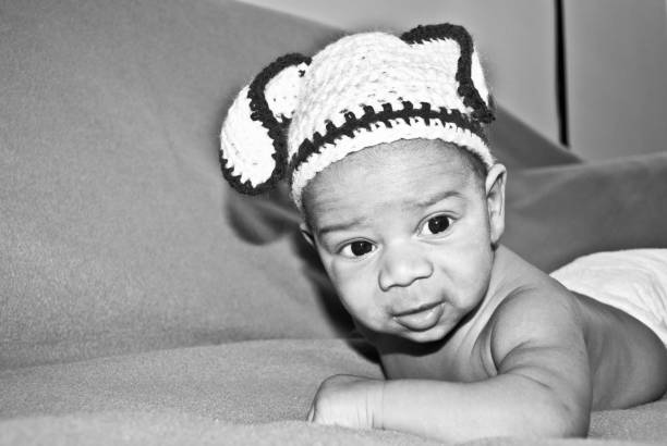 istock Toddler In Knitted Cap On Fabric. Black And White / Monochrome 1029289978