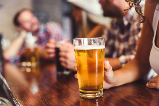 istock Young people drinking beer and laughing together 1029290146