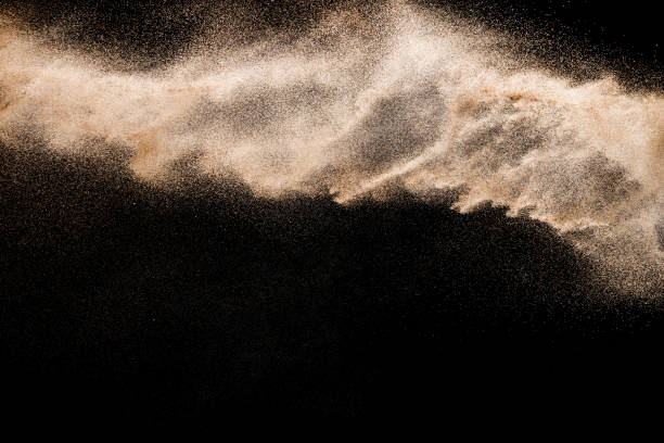 istock Dry river sand explosion. Golden colored sand splash agianst dark background. 1029290590