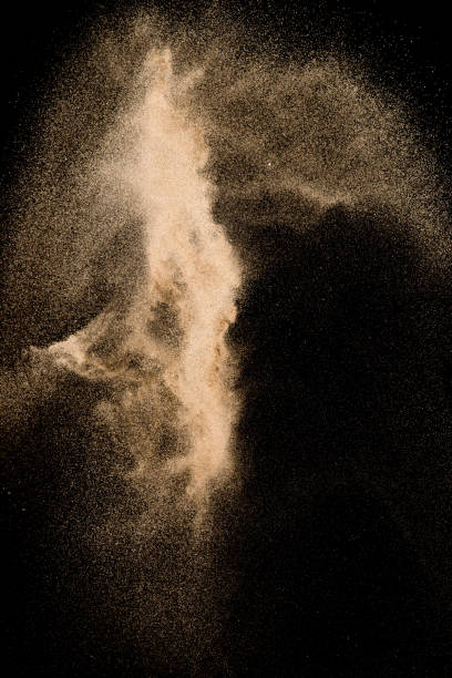 istock Dry river sand explosion. Golden colored sand splash agianst dark background. 1029290606