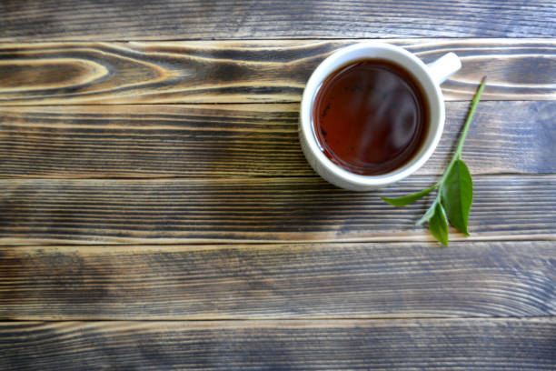 istock tea leaves, tea in a cup on a wooden background tea concept 1029290788