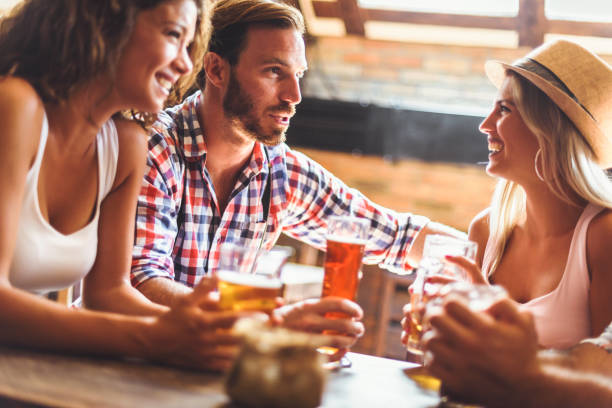 istock Young people drinking beer and laughing together 1029297054