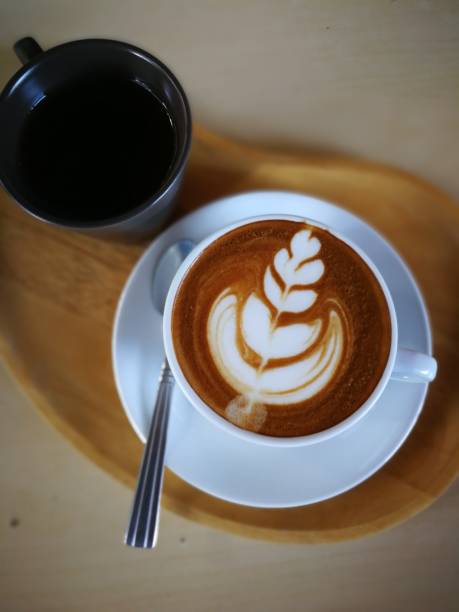 istock Hot cappuccino in a white cup, placed on a wooden floor. 1029297114