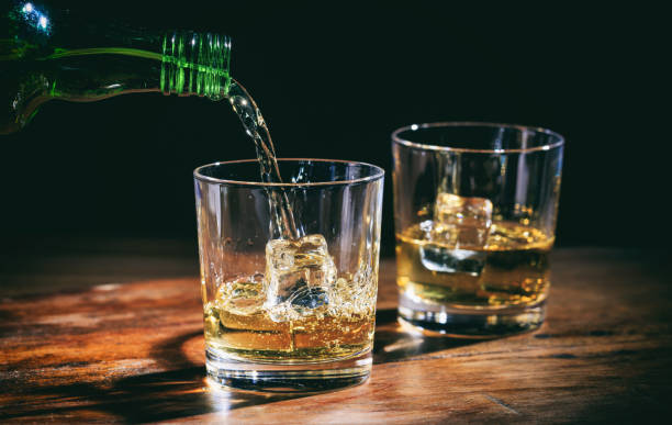 istock Pouring whiskey in glasses 1029297164