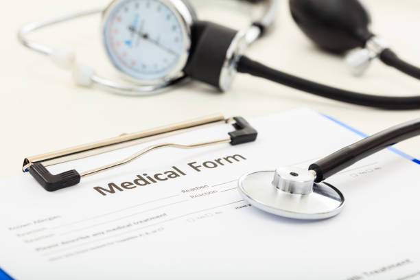 istock Medical form and a stethoscope on a desk 1029297310