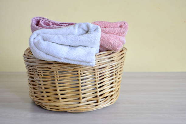 istock Wicker basket with towels on a light background 1029297522