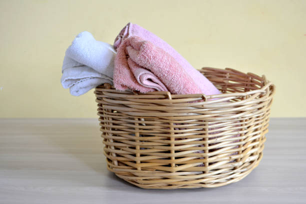 istock Wicker basket with towels on a light background 1029297532