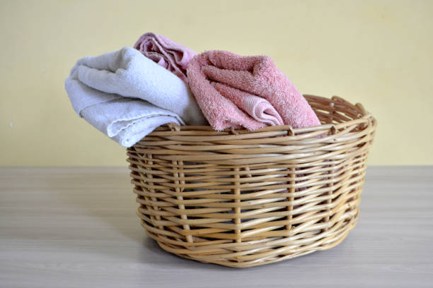 istock Wicker basket with towels on a light background 1029297570