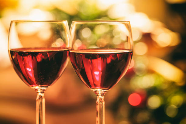 istock Two glasses of wine near a fireplace 1029298044