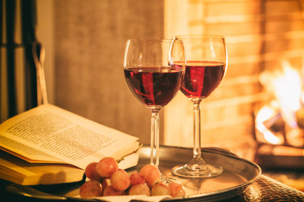istock Two glasses of wine near a fireplace 1029298056