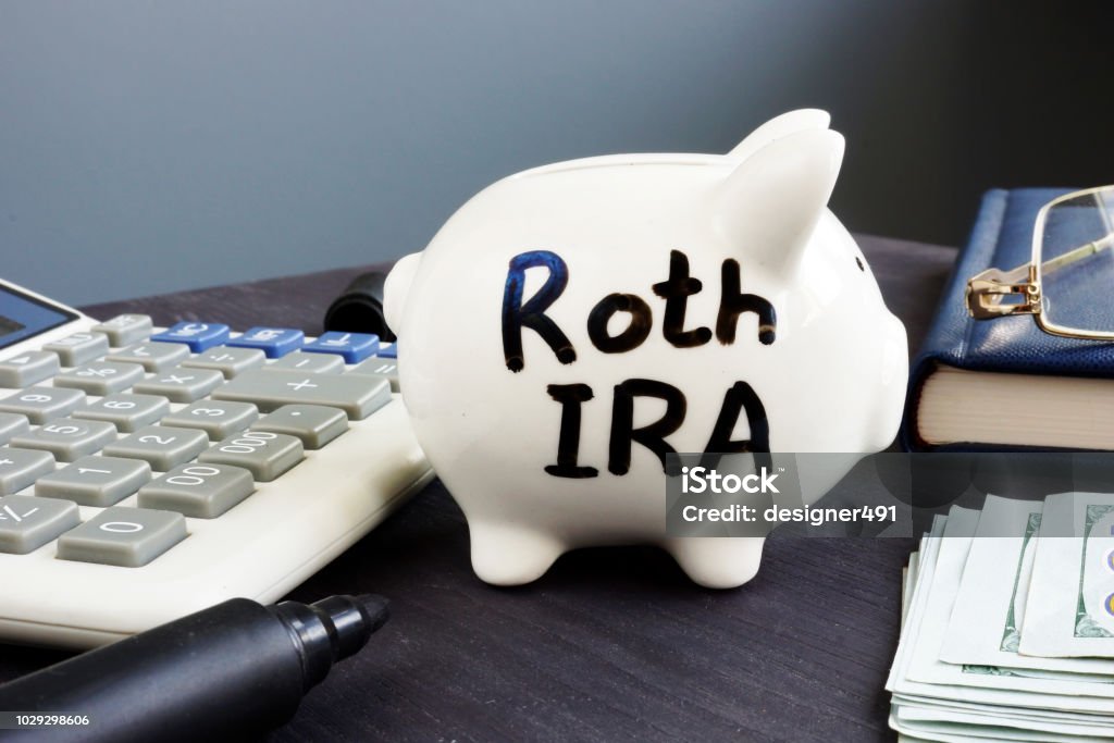 Roth IRA written on a piggy bank. Retirement plan. Pension Stock Photo