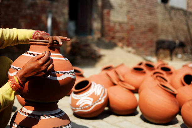 istock Women painting mud pot 1029301914