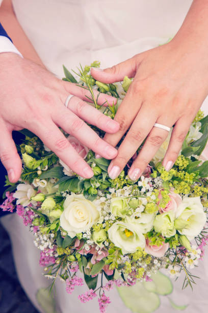 istock Newlywed hands with rings 1029304078