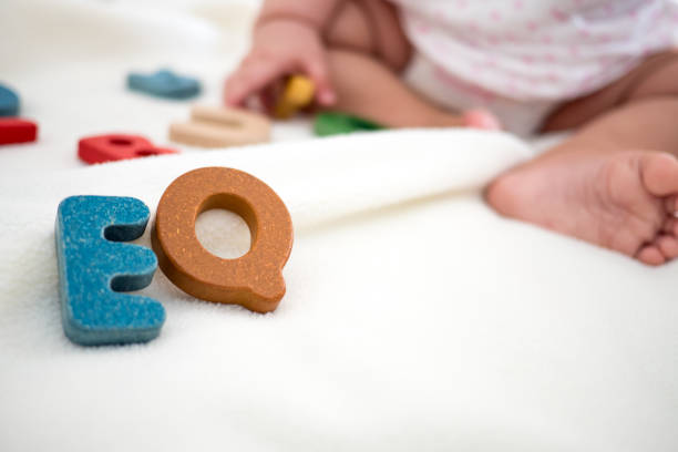 istock EQ text wooden word on blanket with blurred kid foot and copy space background, 1029304086
