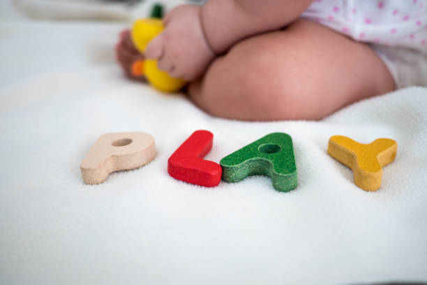 istock Play text wooden word on blanket with foot kid and copy space background 1029304206